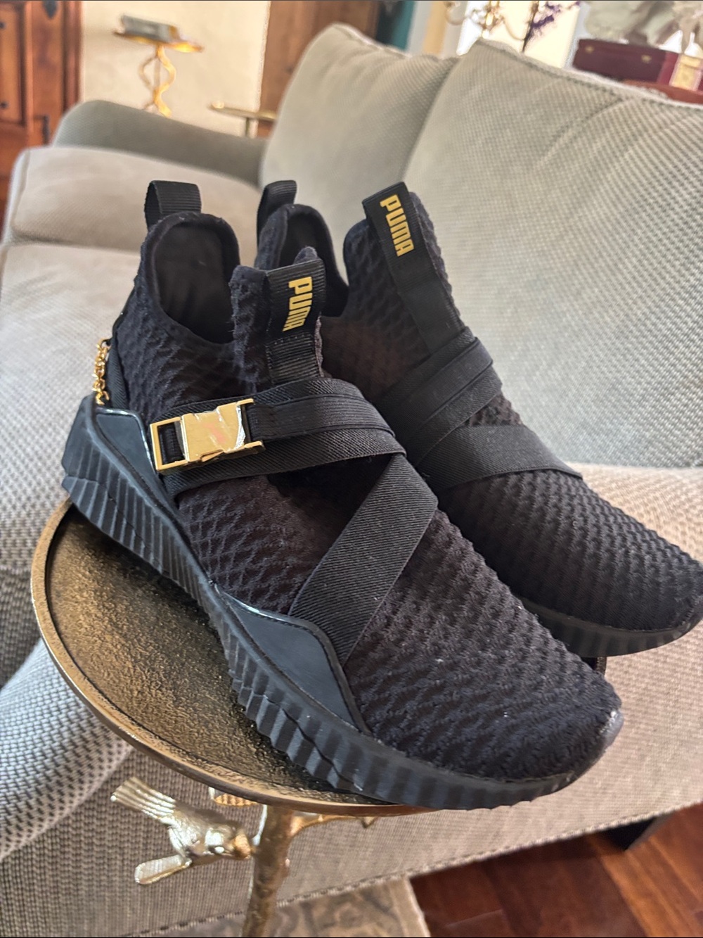 PUMA women’s Black Slip-On Athletic Sneakers with Gold Accent